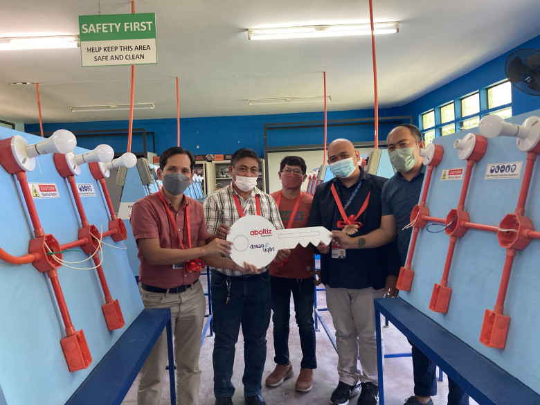E Ramos NHS. Davao Light head Fermin Edillon turns over the key to the refurbished EIM laboratory at Emilio Ramos National High School.